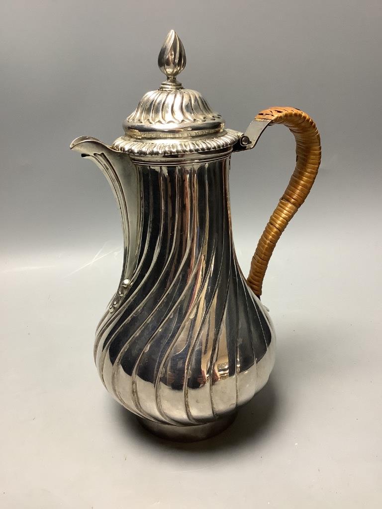 A George III silver hot water jug of wrythen baluster form